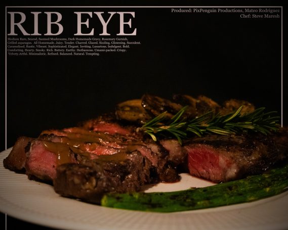 Ribeye steak with herbs and asparagus on a plate against a dark background.